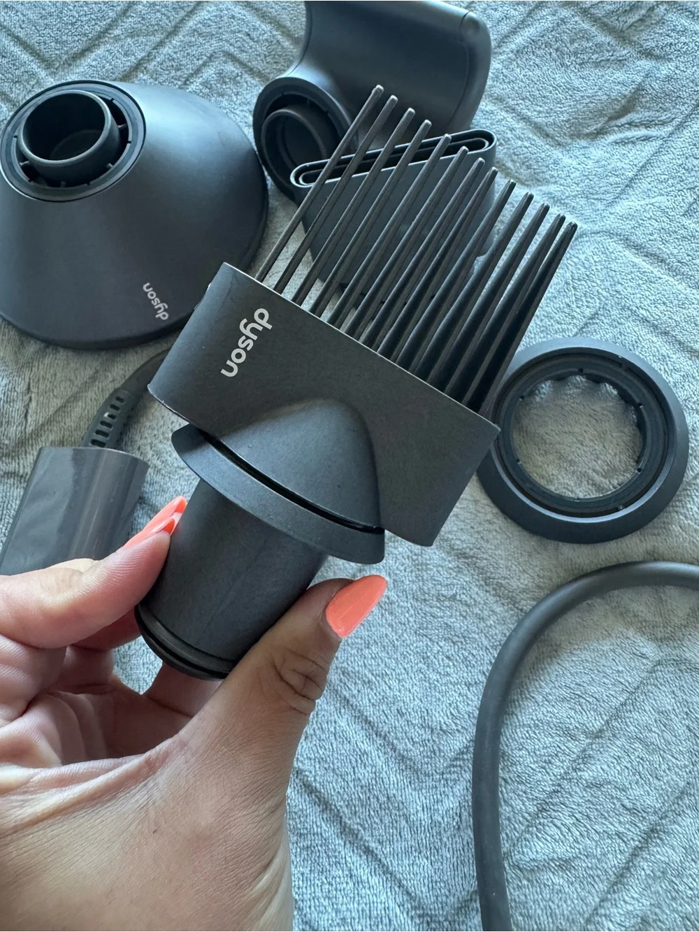 Dyson Hair Dryer with Multiple Black and Gray Styling Attachments